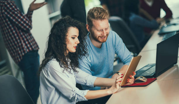 istock Programmers and business people collaborating in company office 655381408