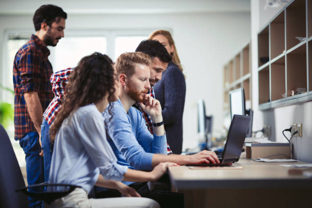istock Programmers and business people collaborating in company office 655381428
