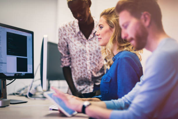 istock Programmers and business people collaborating in company office 655381790