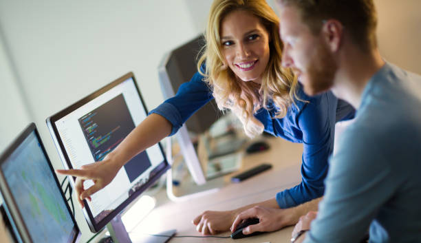 istock Programmers and business people collaborating in company office 655384004