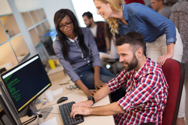 istock Coworkers working on project together in company office 655384208