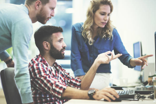 istock Programmers and business people collaborating in company office 655384924