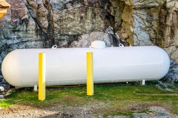 White Propane Tank Outdoor White Gas Tank in the Backyard of a House and in front of a Rock Wall whiteface mountain stock pictures, royalty-free photos & images