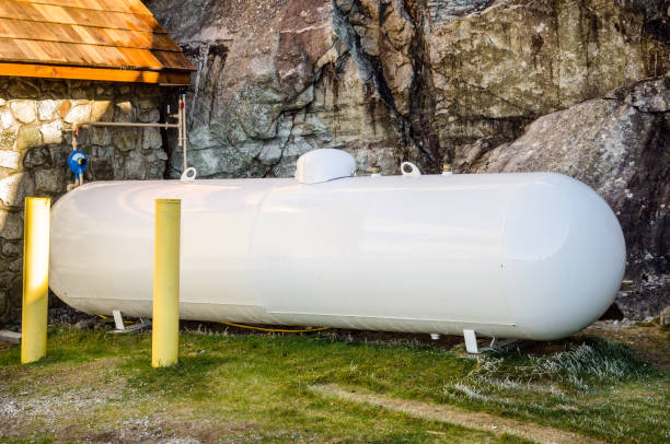 Backyard Propane Tank Cylindrical White Propane Tank in the Backyard of a Mountain House whiteface mountain stock pictures, royalty-free photos & images