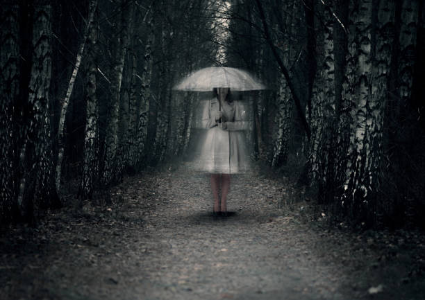 istock Ghost woman stands on a dark path in the forest 655404074