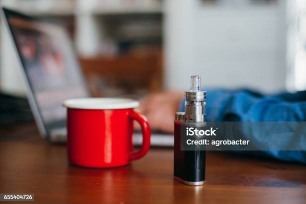 Ecigarette Standing On A Table Stock Photo - Download Image Now - Electronic Cigarette, Coffee - Drink, Table