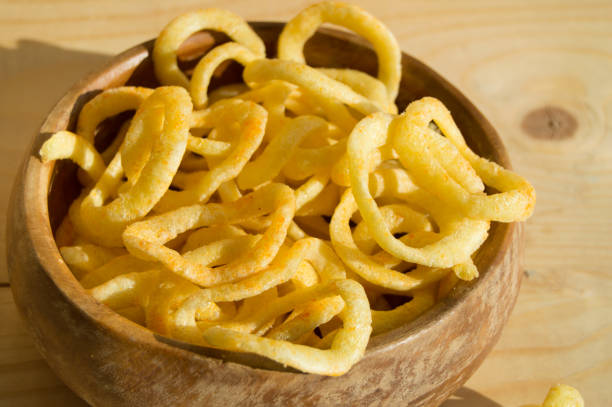 istock Onion rings chips in a wooden bowl on a Board 655413602