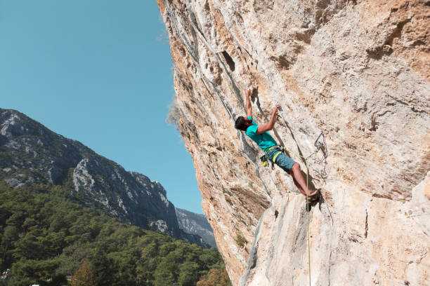 istock Mature Man climbing high Rock breaking the Limits 655413664