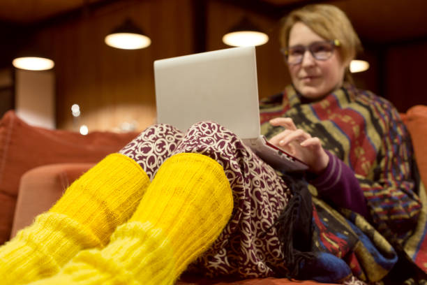 istock Woman in traditional Clothing using Computer cozy suburban Villa interior 655414244