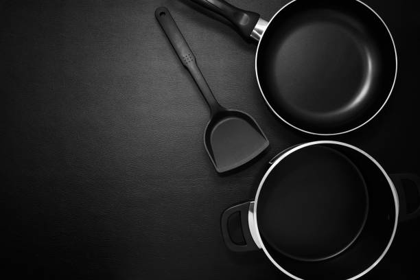 istock Top view frying pan and pot on black table. 655414666