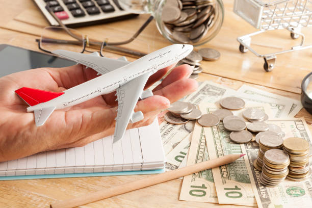 istock airplane model in hand and money banknote,coins 655415026