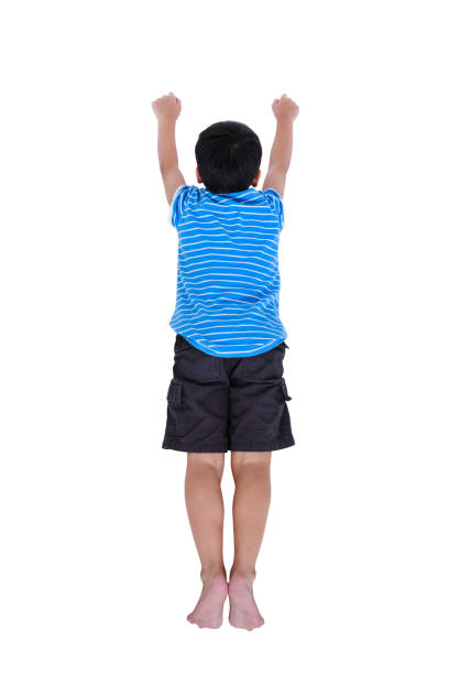 Top view of happy asian child look like flying superhero. stock photo