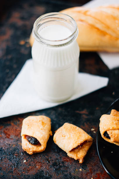 istock Bottle of milk with the fresh bakery over rustic surface. 655421864
