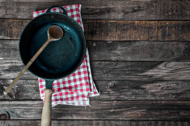 istock Black frying pan with a wooden spoon 655425170