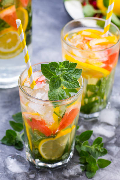 istock Cold refreshing summer lemonade in a glass on a grey concrete or stone background. 655446420
