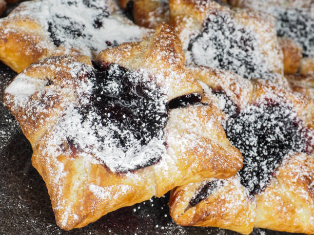 istock Danish pastry with blueberry jam filling with white powdered sugar 655446648