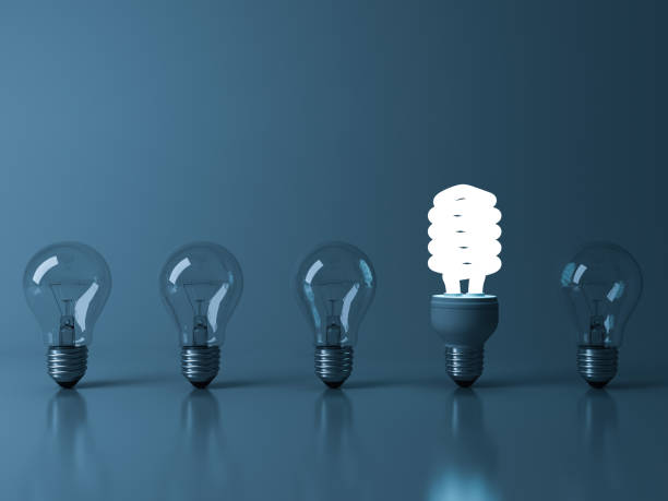 istock Eco energy saving light bulb , one glowing fluorescent lightbulb standing out from unlit incandescent bulbs reflection on green background , individuality and different ideas concepts 3D rendering 655446974