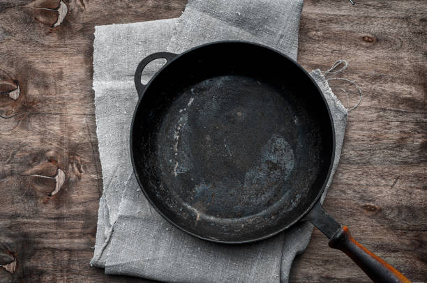 istock Empty black cast-iron frying pan on a textile napkin 655453274