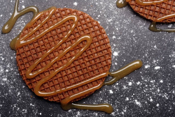 Stroopwafels with caramel sauce on a slate surface
