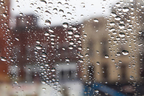 istock city buildings through rain on window 655457800