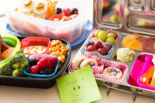 Mom packs a happy note of encouragement with a colorful Bento box lunch packed with healthy fruits, veggies and snacks