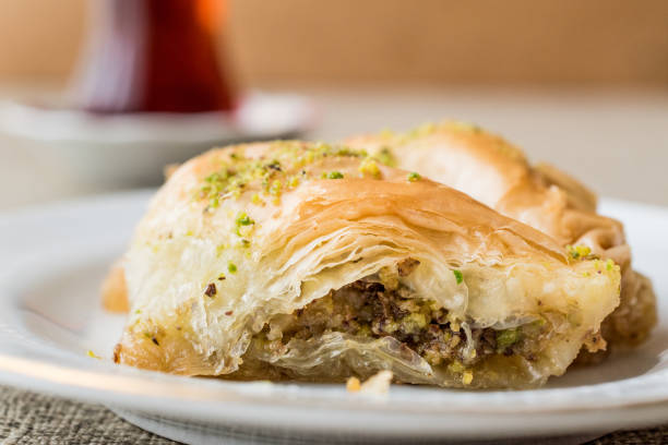 istock Turkish Baklava sobiyet with pistachio and tea. 655457992