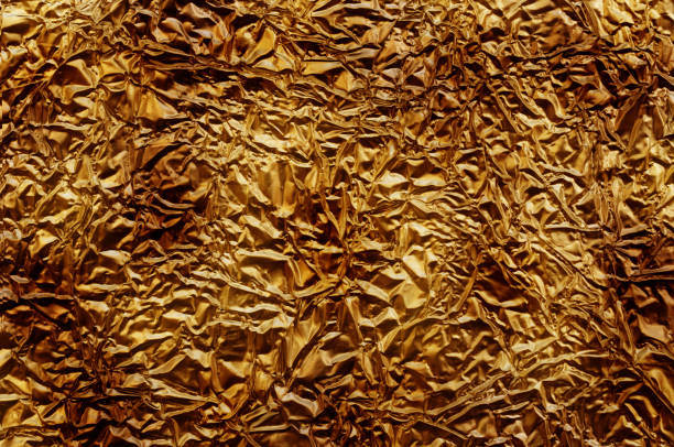 istock Brass. Shiny red paper texture. Foil background 655458762