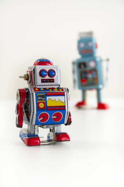 istock Pair of vintage tin toy robots isolated on white background 655458904