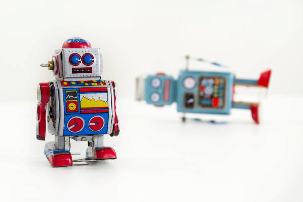 istock Pair of vintage tin toy robots isolated on white background 655458944