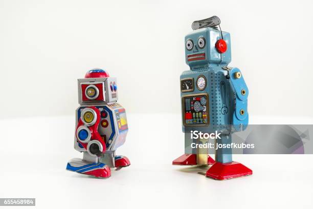 Pair Of Vintage Tin Toy Robots Isolated On White Background Stock Photo - Download Image Now
