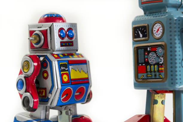 istock Pair of vintage tin toy robots isolated on white background 655459104