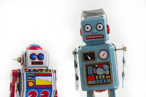 istock Pair of vintage tin toy robots isolated on white background 655459282
