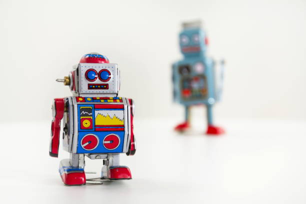 istock Pair of vintage tin toy robots isolated on white background 655462070