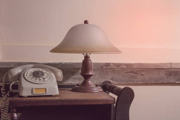 Vintage - Old gray phone and  retro lamp on the desk - 80's concept image