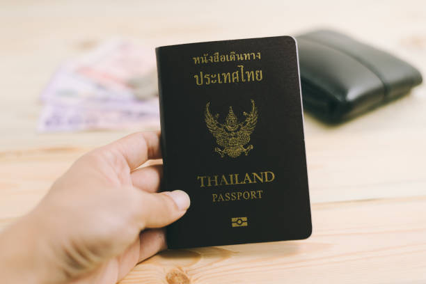 istock Thailand passport and Thai money 655468538