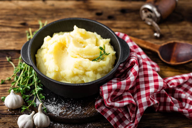 istock Mashed potatoes, boiled puree in cast iron pot on dark wooden rustic background, top view 655471622