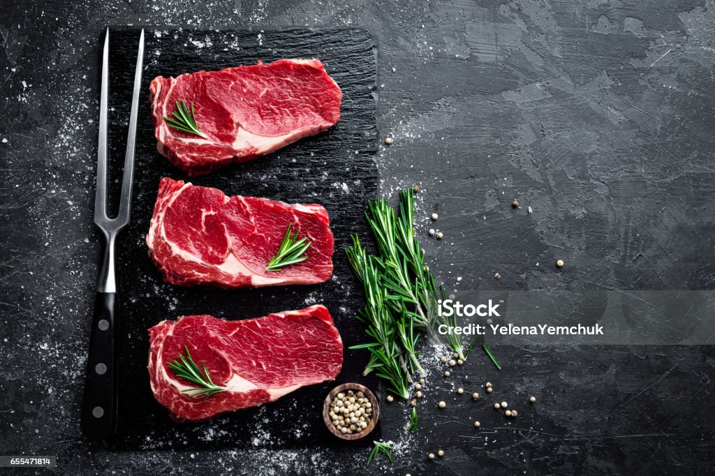 Raw meat, beef steak on black background, top view Meat Stock Photo