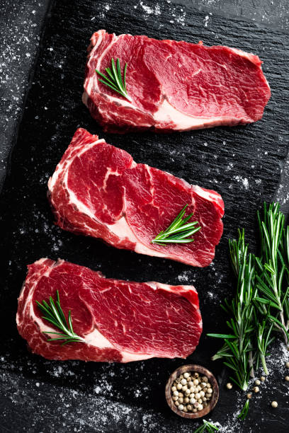 istock Raw meat, beef steak on black background, top view 655471818