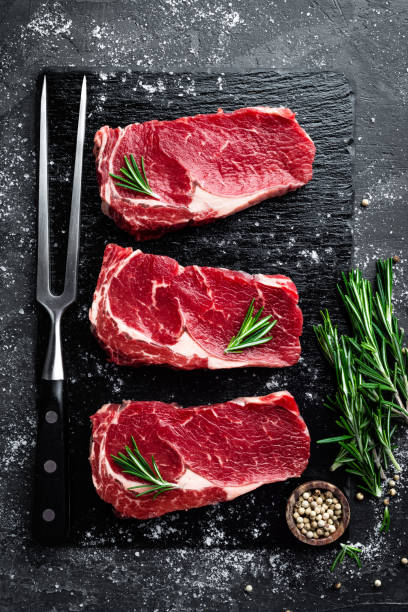 istock Raw meat, beef steak on black background, top view 655471822