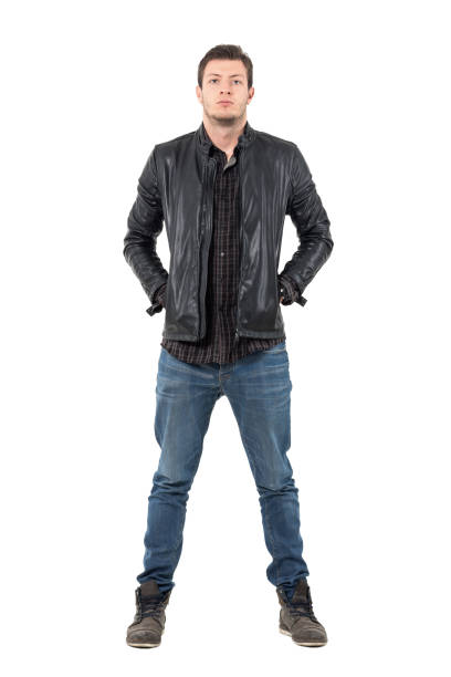 istock Front of young man in jeans and jacket with hands in pockets looking at camera. 655474530