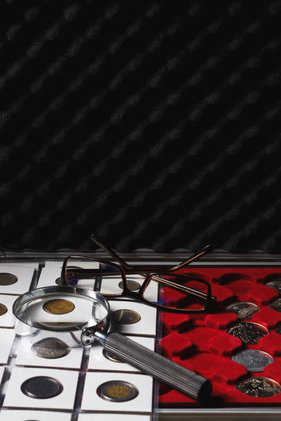 istock Box with collectible coins and magnifying glass 655475308