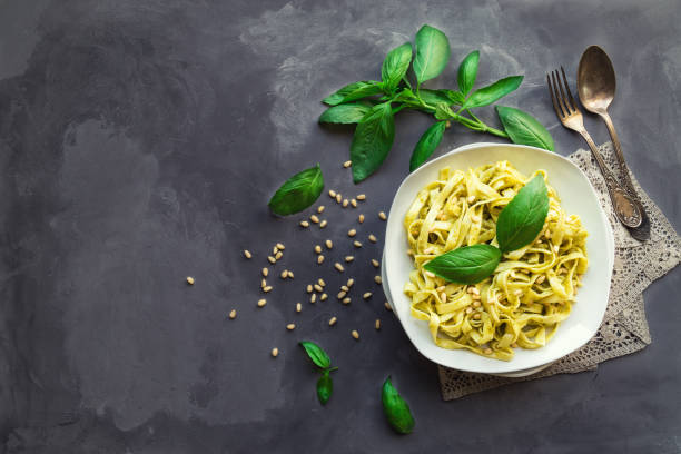 istock Fettuccine pasta with pesto sauce, basil and pine nuts on concrete background 655475676