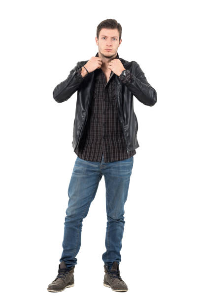 istock Handsome young man adjusting collar of black leather jacket looking at camera. 655475716