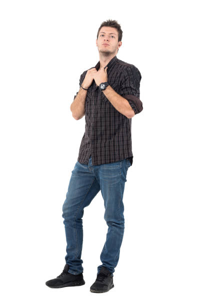 istock Serious casual man wearing jeans and checked gray shirt pulling collar 655476116