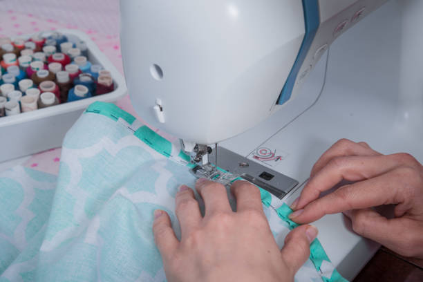 istock Woman's hands with dress at sewing machine 655479150