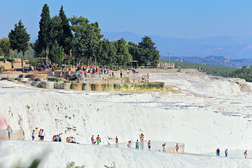 People at Pamukkale travertines. Layers of travertines form terraces of carbonate minerals in Pamukkale, Southwest Turkey - 09/25/2013