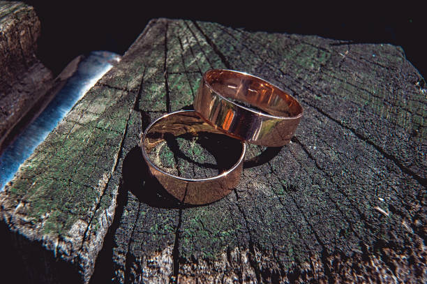 istock wedding ring on the old wooden stump 655486182