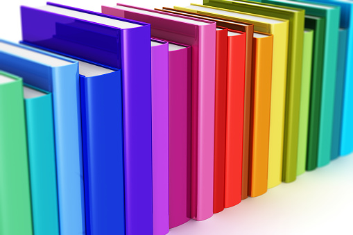 Creative abstract science, knowledge, education, back to school, business and corporate office life concept: 3D render illustration of the macro view of rainbow color hardcover books isolated on white background with selective focus effect