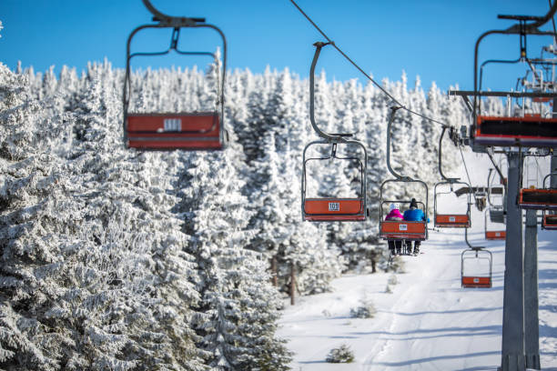 ski lift with skiers being carried up the hill - czech republic ski winter skiing imagens e fotografias de stock