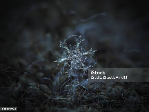 Real Snowflake Glitters On Dark Gray Woolen Background Stock Photo - Download Image Now